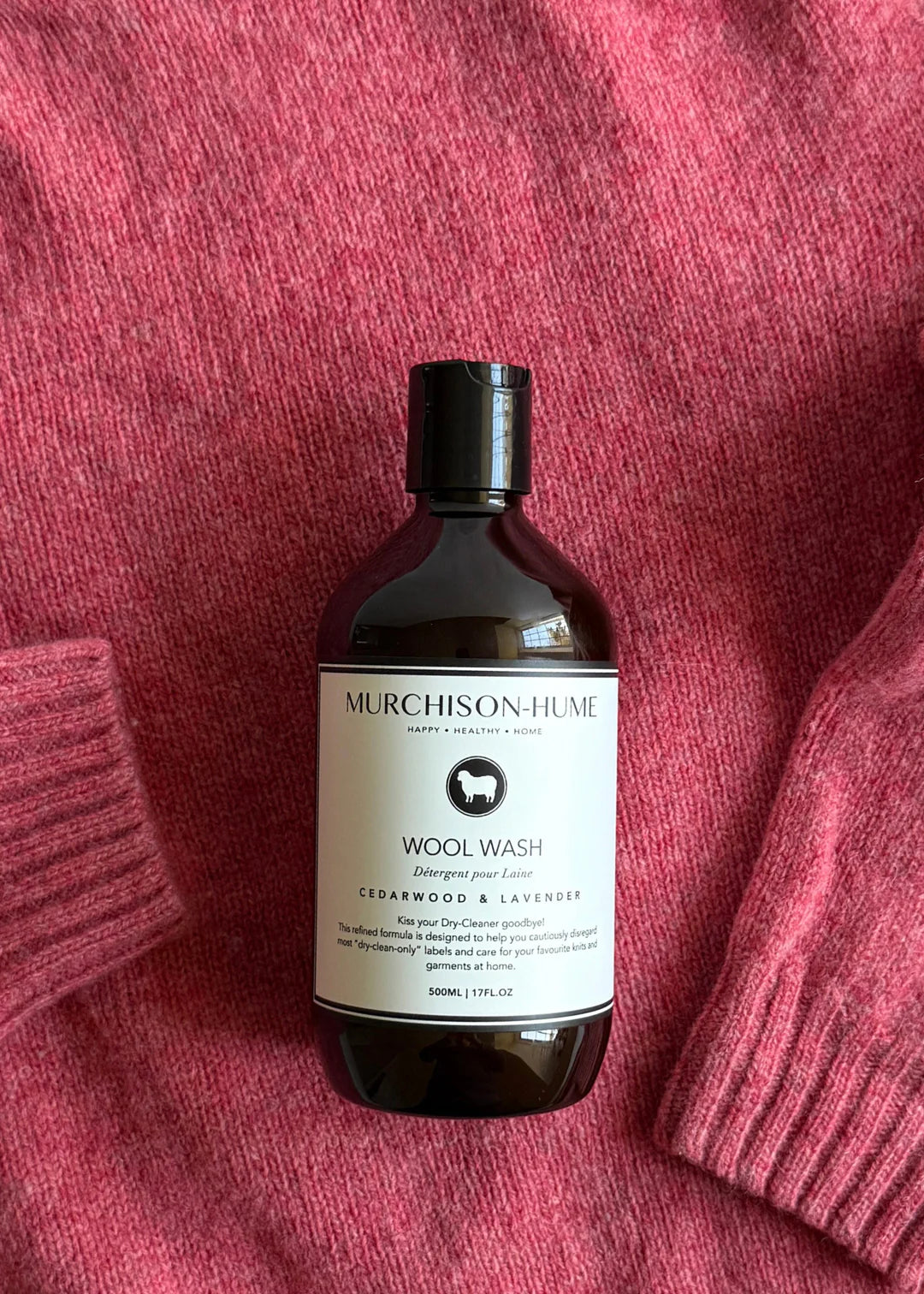 Murchison-Hume Wool Wash bottle on a pink textured fabric background