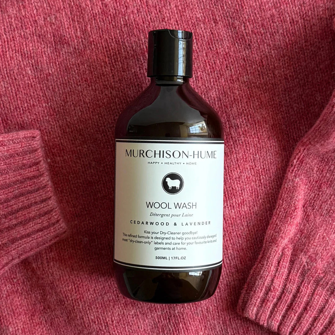 Murchison-Hume Wool Wash bottle on a pink textured fabric background