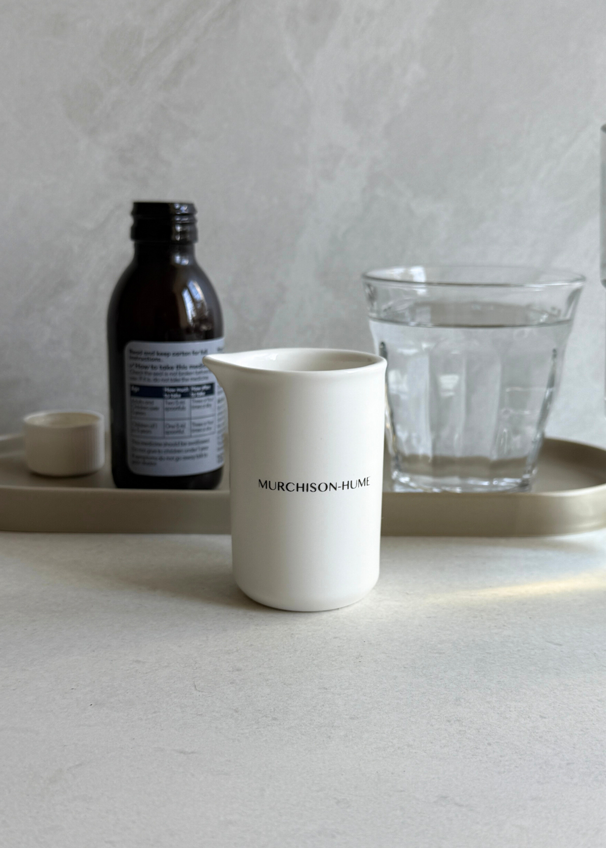 Murchison-Hume ceramic measuring cup on a laundry shelf