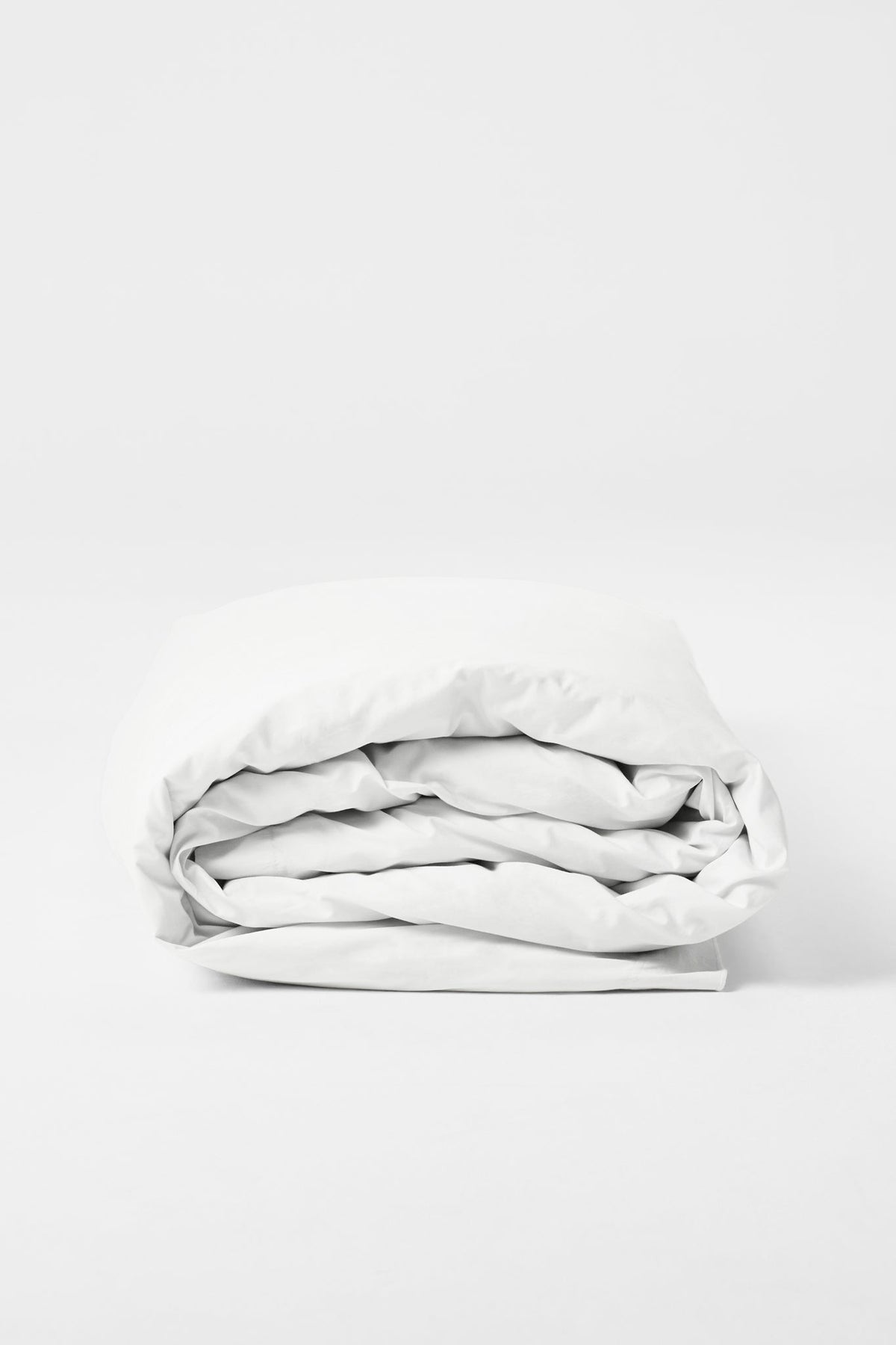 Studio Sutram Prism duvet cover in pure white, side view showing the framing border