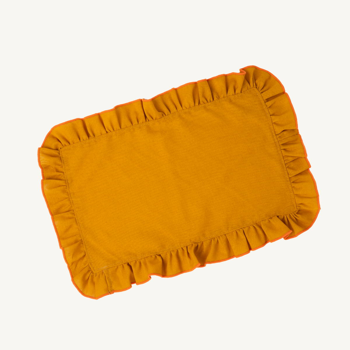 Mesa Collections ruffled placemat in golden sand with orange trim