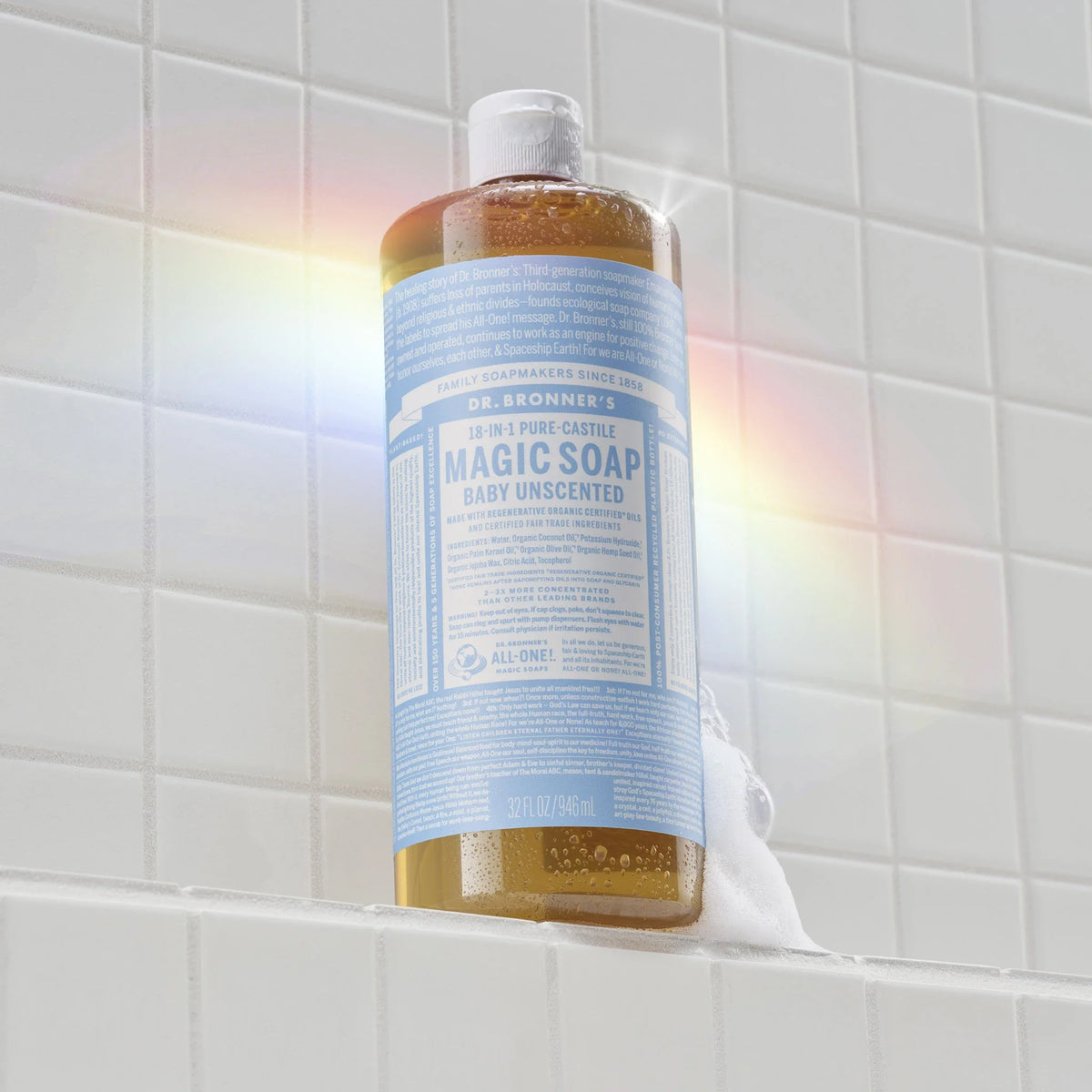 Dr. Bronner's Baby Unscented Pure-Castile Magic Soap 946ml bottle on a tiled shower ledge