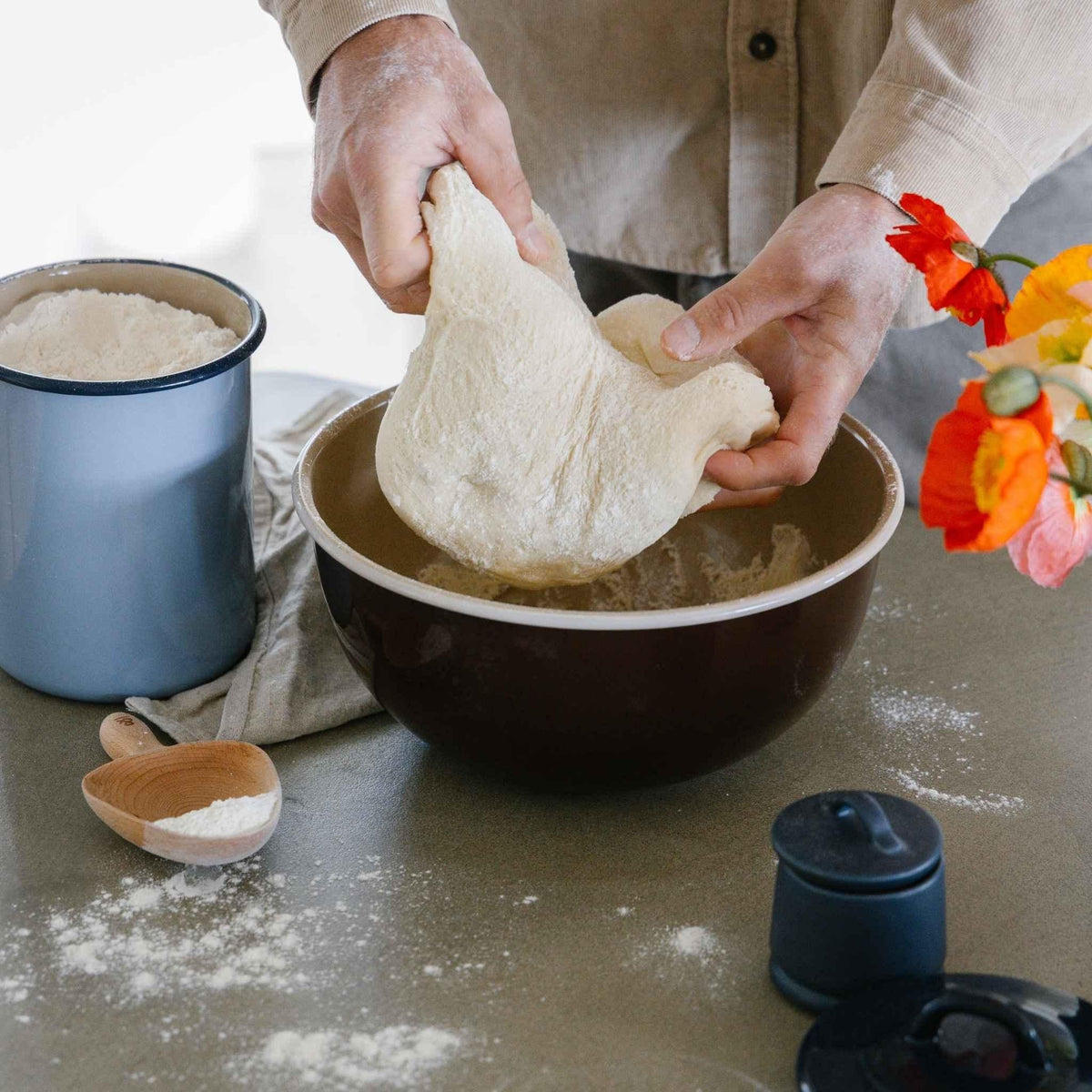 Bread dough being kneaded in a Macadamia enamel mixing bowl