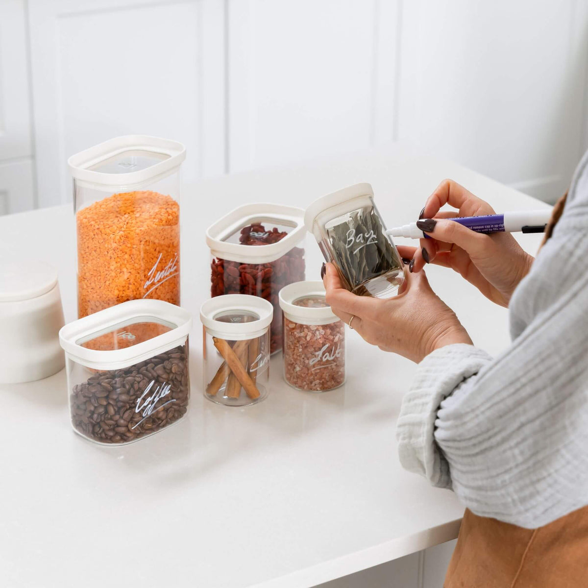 Tallow glass pantry jars storing dry goods in a kitchen