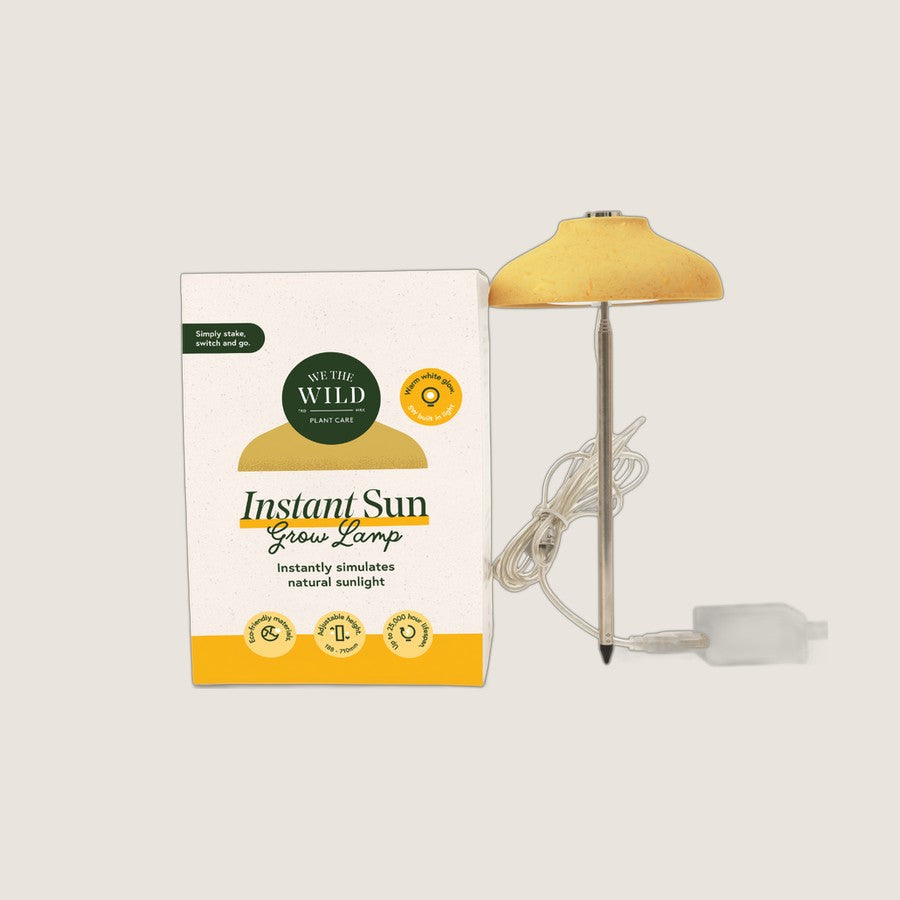 We The Wild Instant Sun Grow Lamp with its box, showing the staked lamp, plug and cable