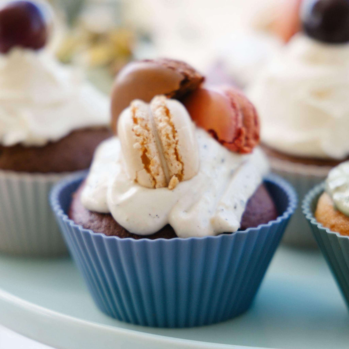Cupcake topped with a macaron in a Rain silicone muffin cup