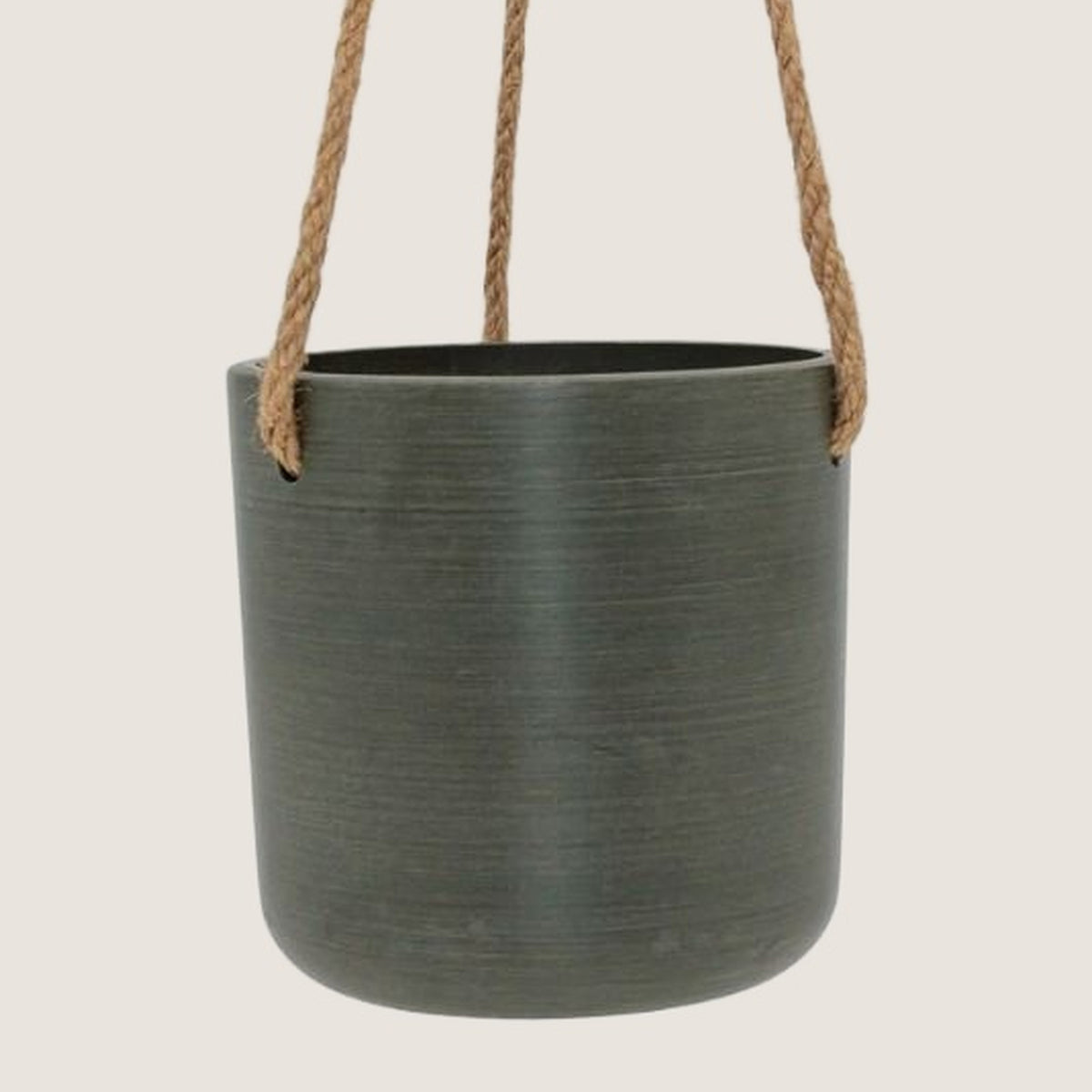 Potted Austin hanging pot in Olive with rope hanger, on a greige background