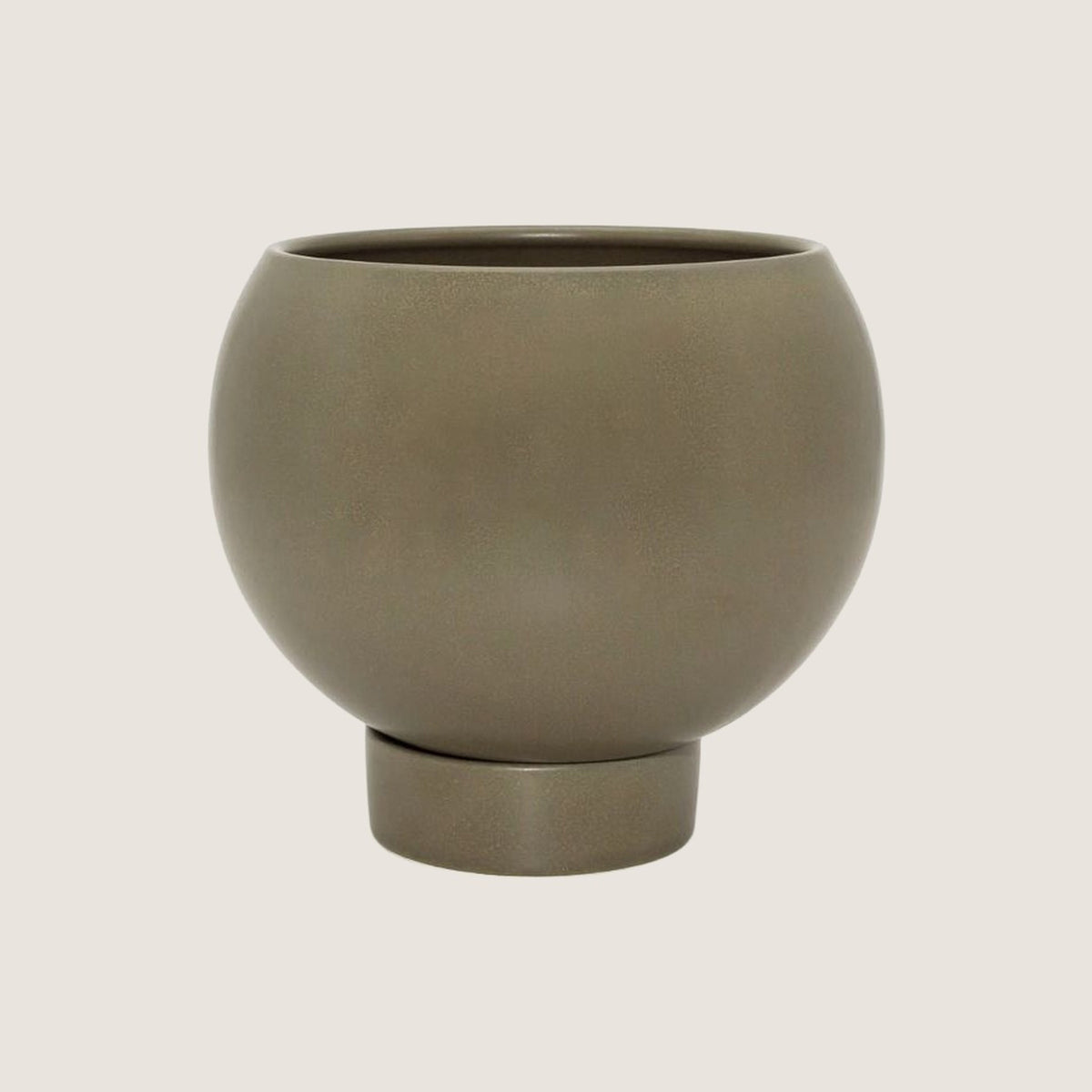 Potted medium Orbit plant pot in Jade on a greige background