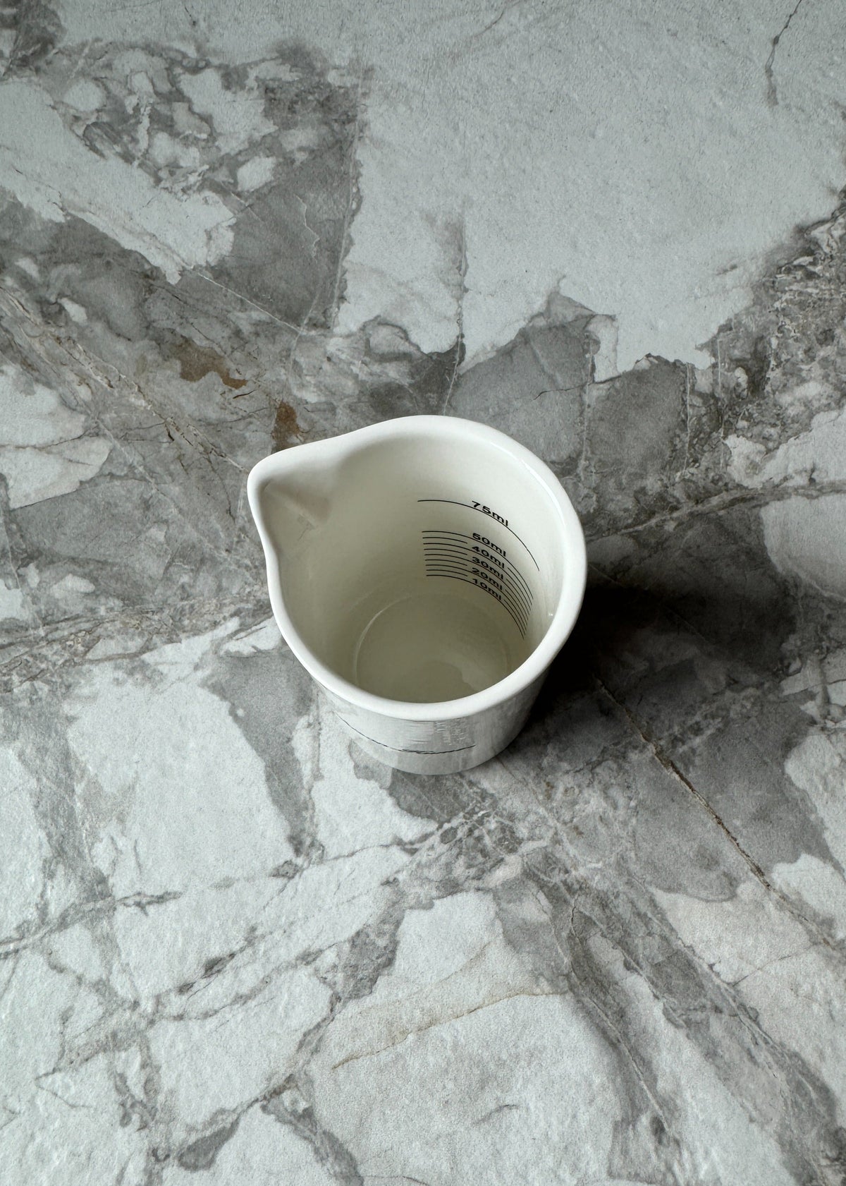 Inside the Murchison-Hume ceramic measuring cup showing metric and imperial markings