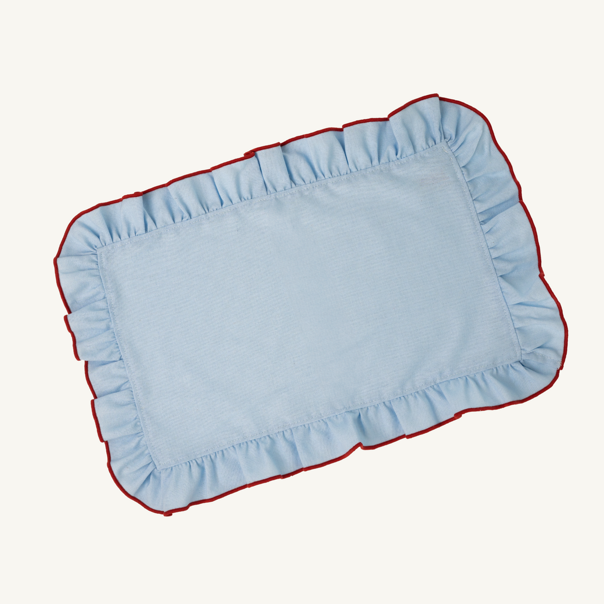 Mesa Collections ruffled placemat in clear sky blue with red trim
