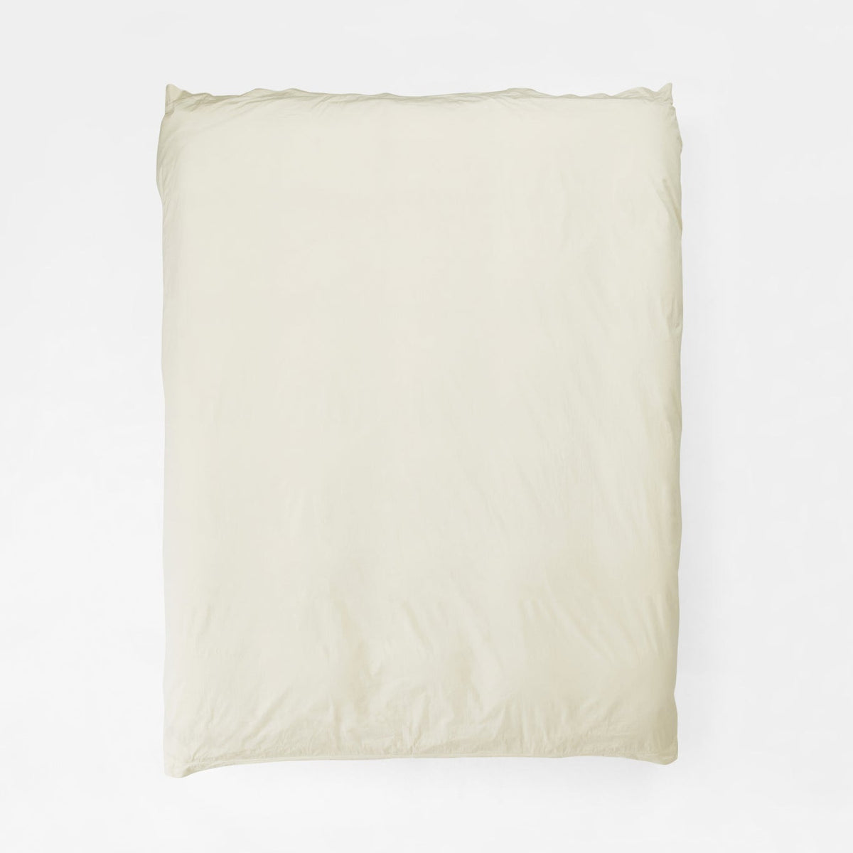 Studio Sutram Canvas duvet cover in warm off-white organic cotton percale on a bed