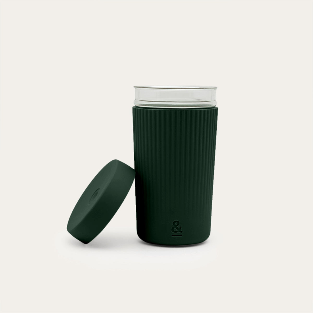 Seed and Sprout Moss smoothie cup with the ribbed silicone sleeve, shown beside its lid