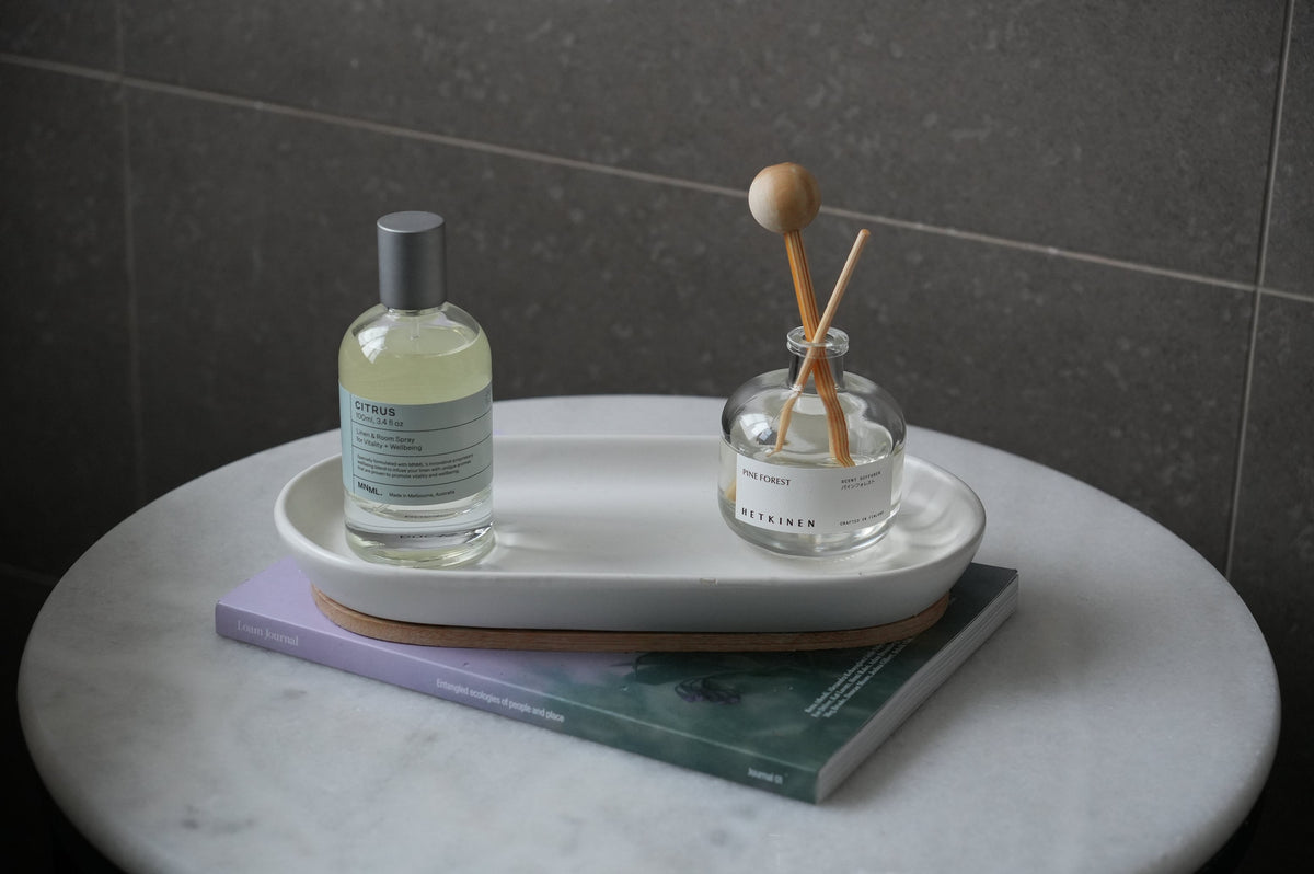 Labelled low-tox bottle and diffuser on a marble tray