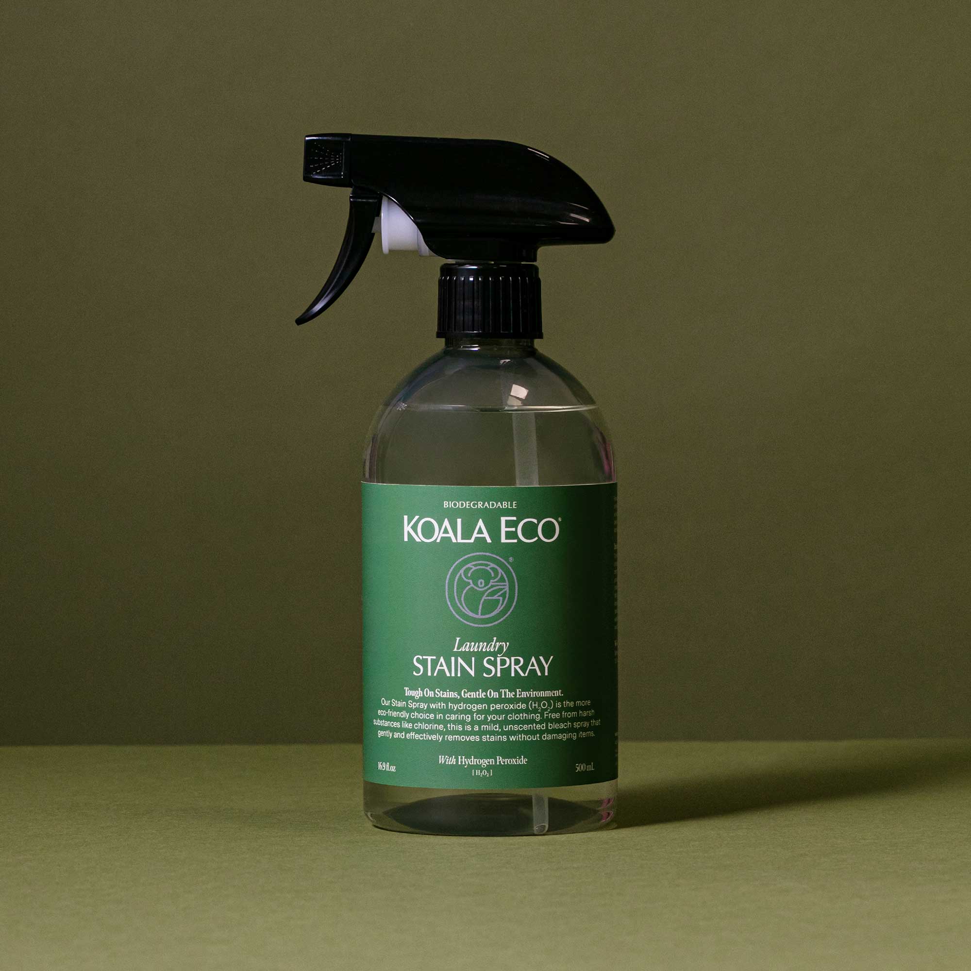 Koala Eco Laundry Stain Spray 500ml bottle photographed against an olive green backdrop