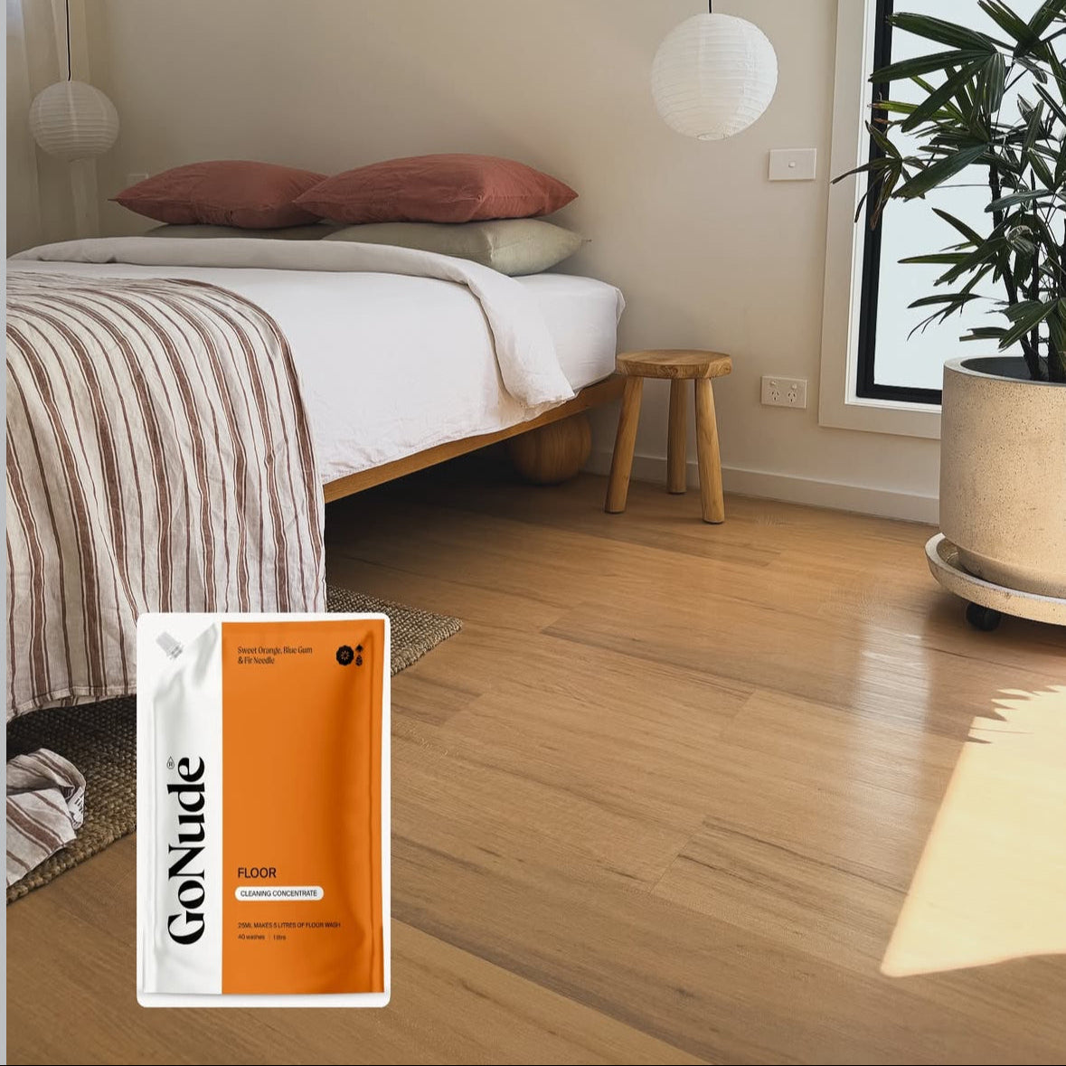 Go Nude Floor cleaning concentrate pouch on timber floorboards in a sunlit bedroom