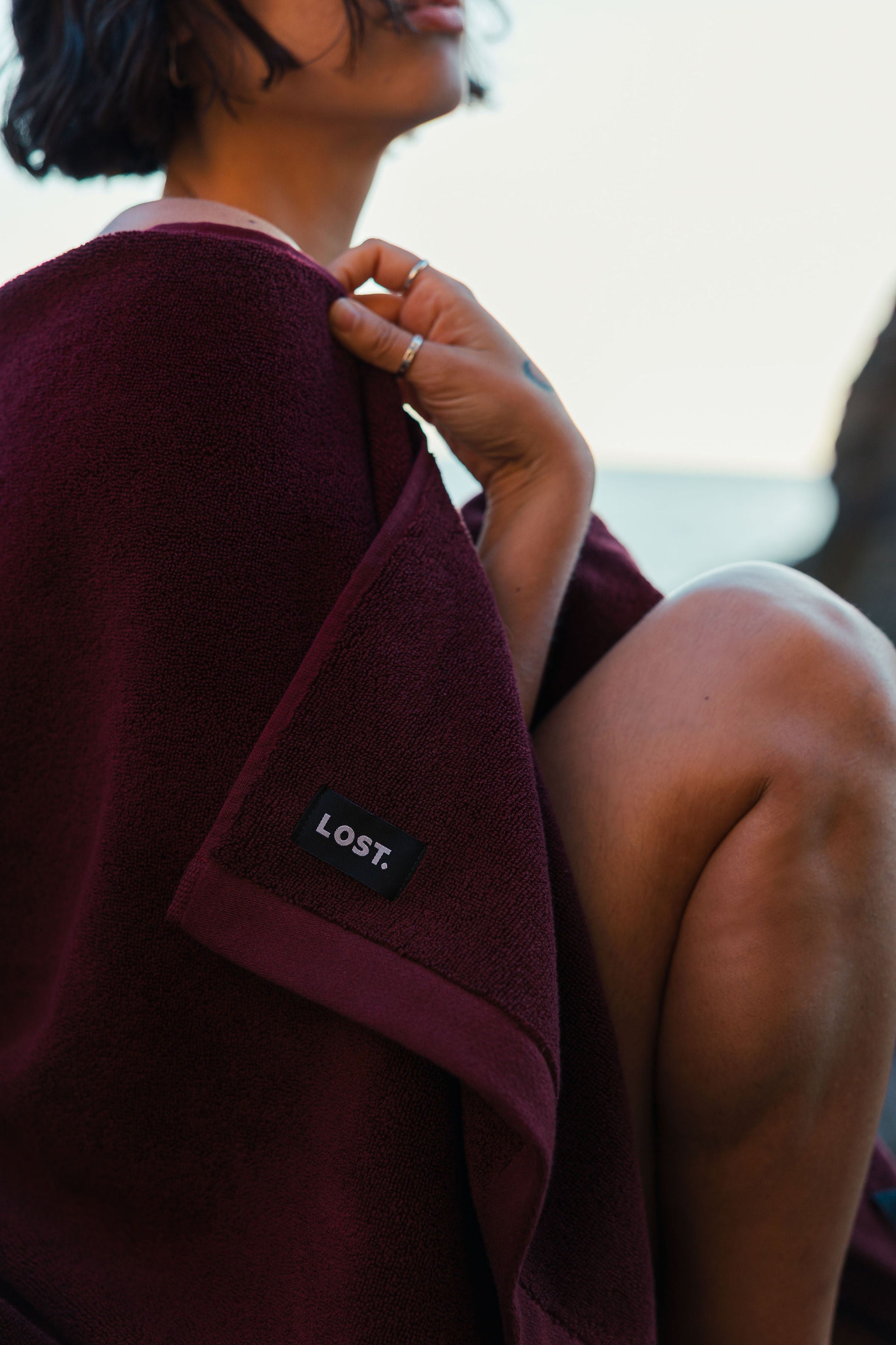 Model draped in a Lost Towels Mulberry organic cotton towel