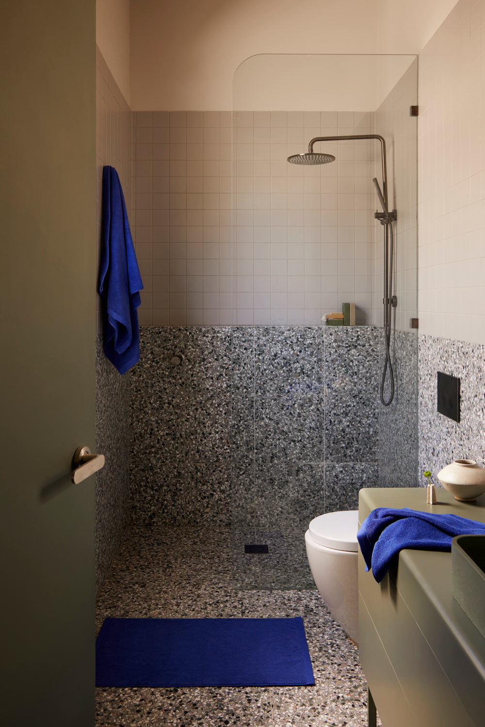 Lost Towels Electric Blue towel and bath mat in a terrazzo bathroom