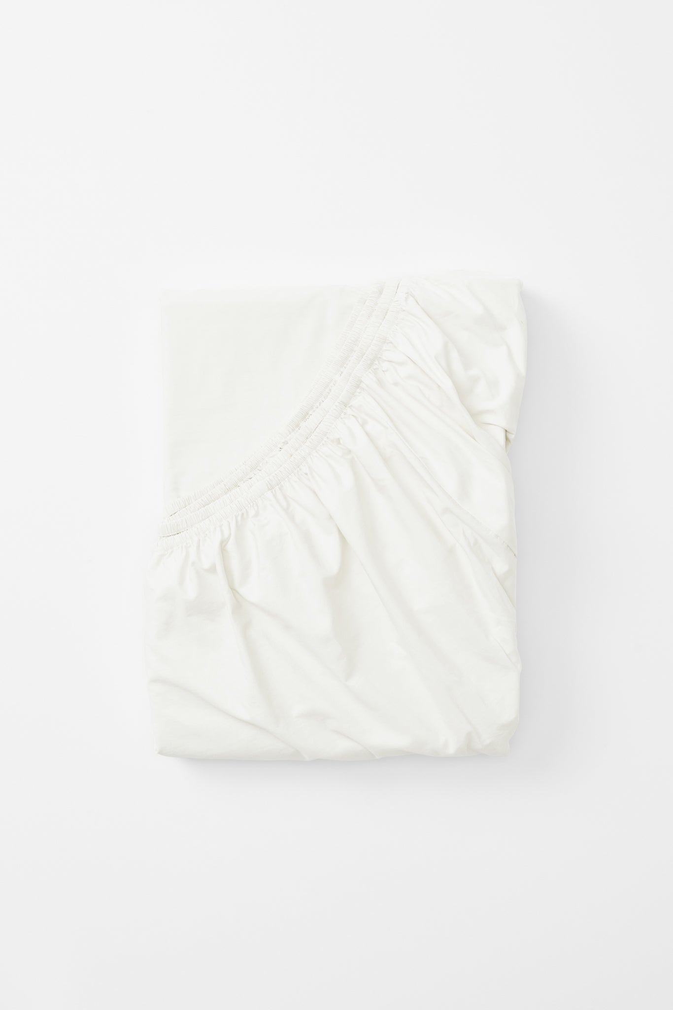 Studio Sutram Prism fitted sheet in pure white organic cotton percale, folded
