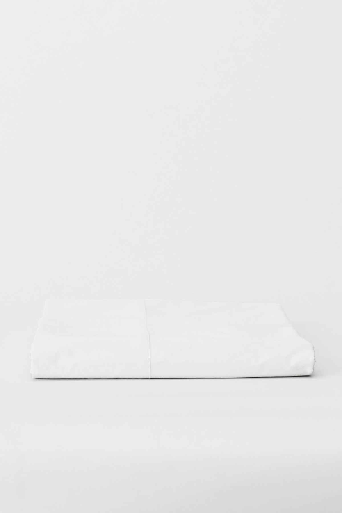 Studio Sutram Prism flat sheet in pure white organic cotton percale, folded