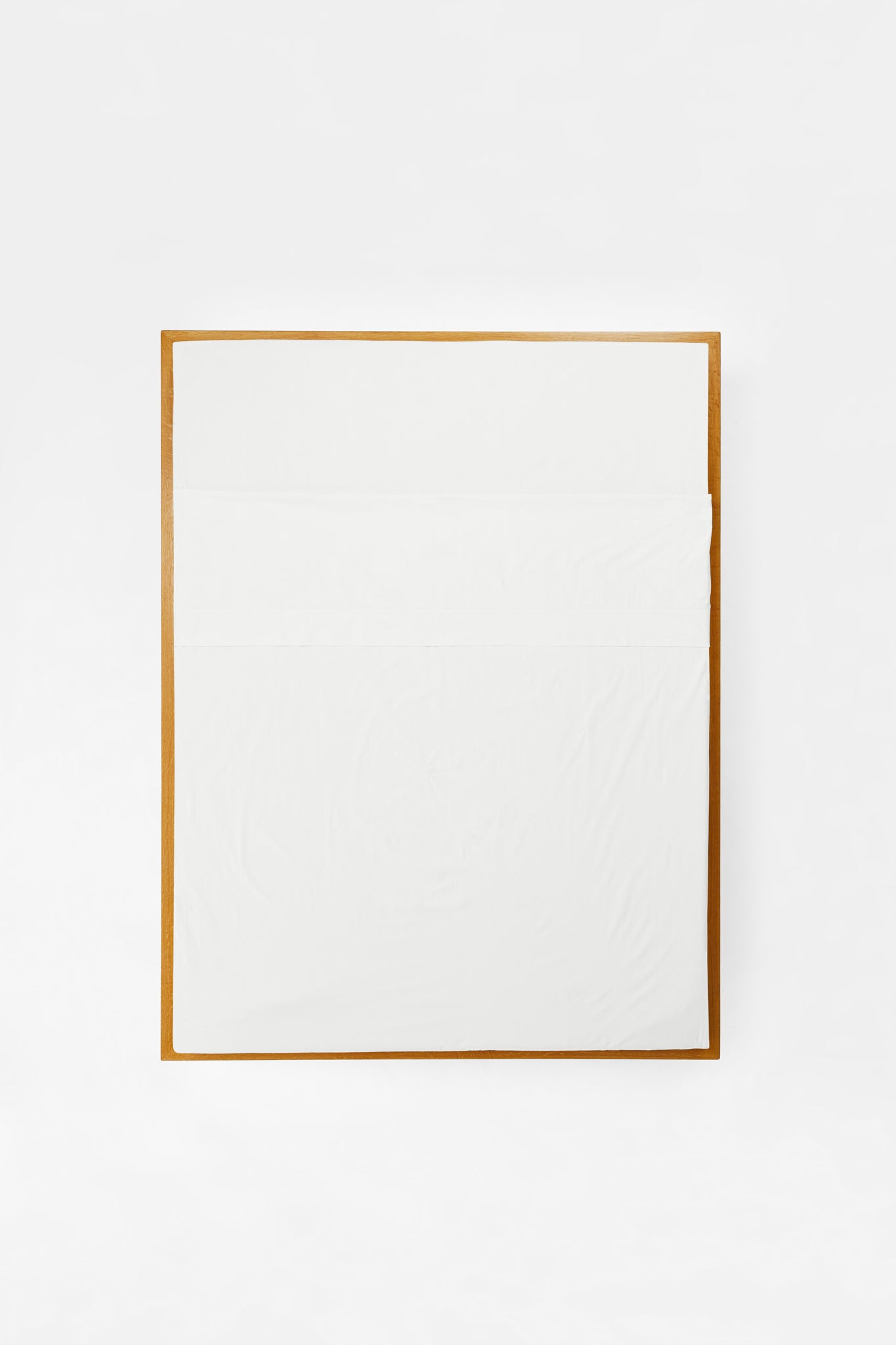 Studio Sutram Prism flat sheet in white organic cotton percale, folded back to show the 10cm header
