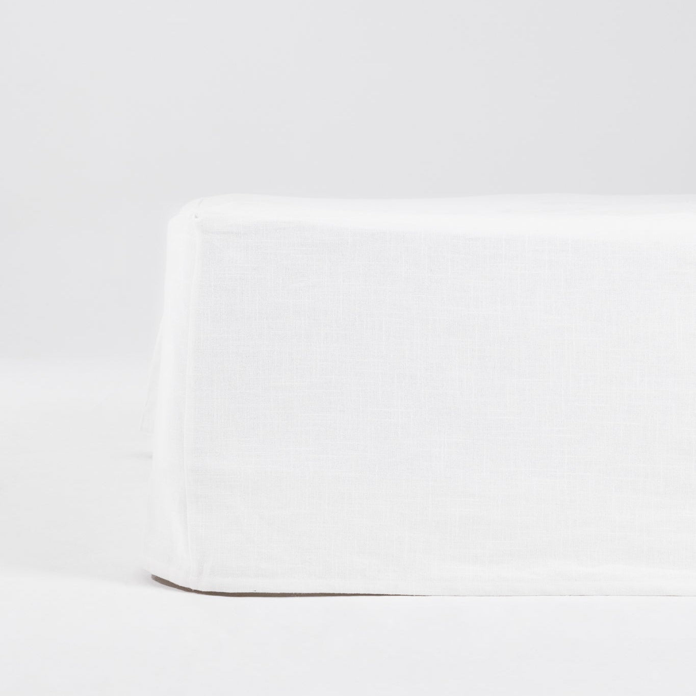 Studio Sutram Prism cotton canvas valance in white, showing the four-sided skirt and 38cm drop over a bed base