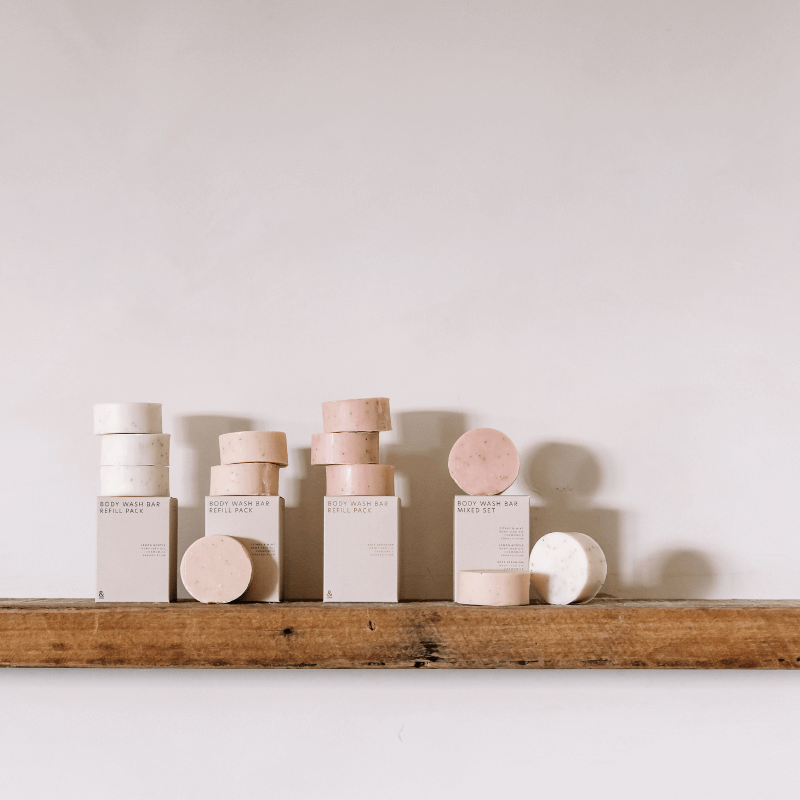 Body wash bars and refill packs on a timber bathroom ledge