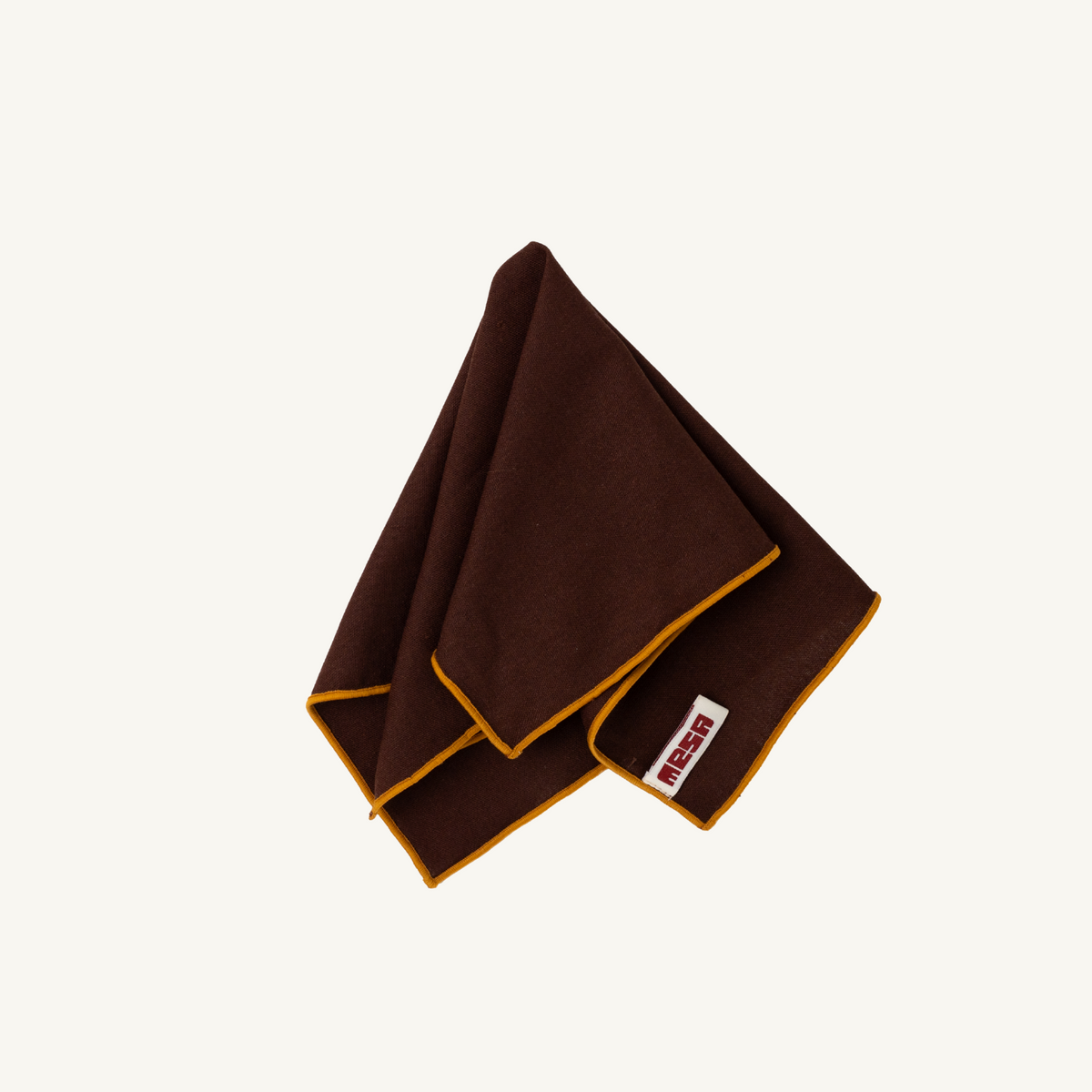 Mesa Collections napkin in wood brown with caramel trim