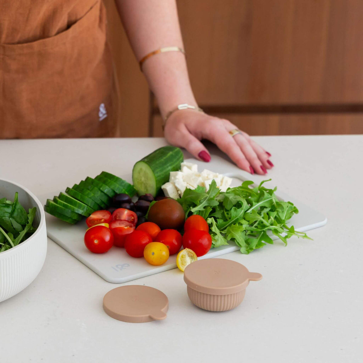 Chopped vegetables and feta on a Mushroom cellulose chopping board