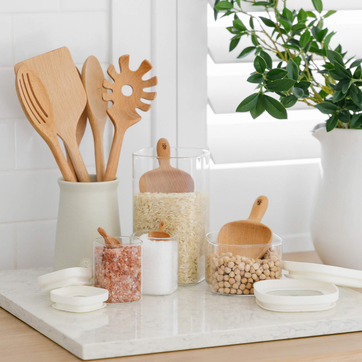 Beechwood kitchen utensils in a crock on a bench