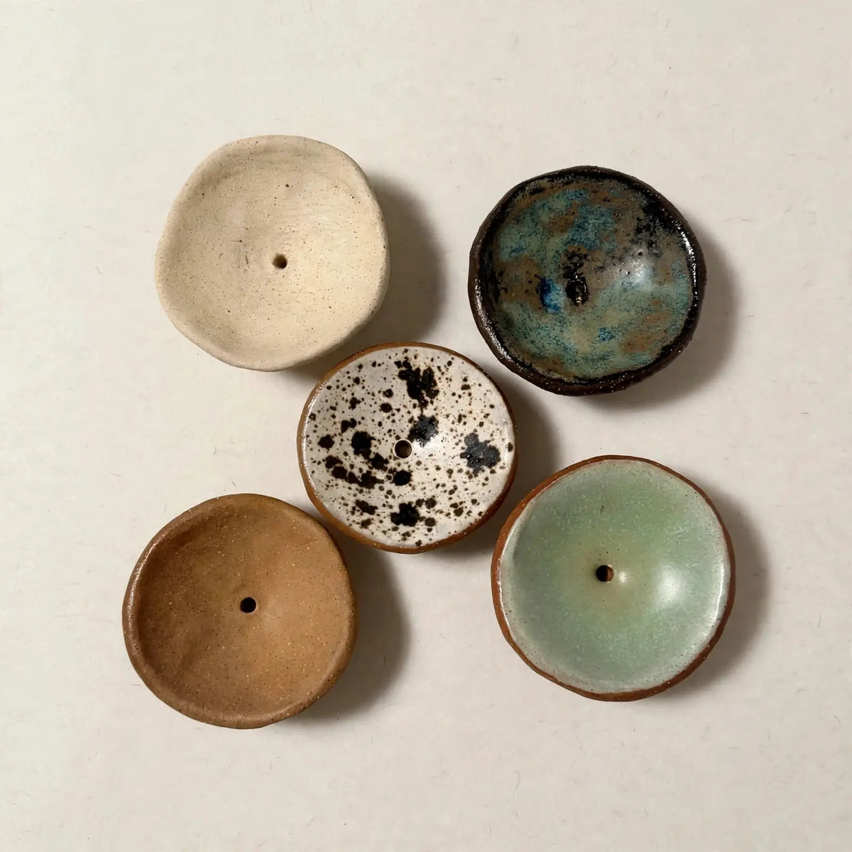 Handmade ceramic incense holder bowls showing natural variation in glaze and colour