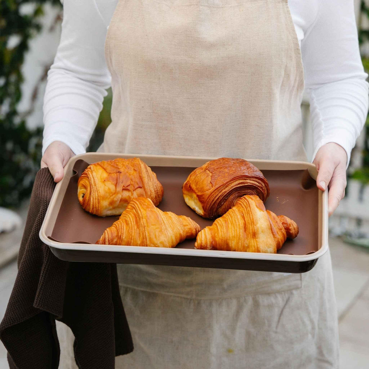 Macadamia enamel baking tray with croissants