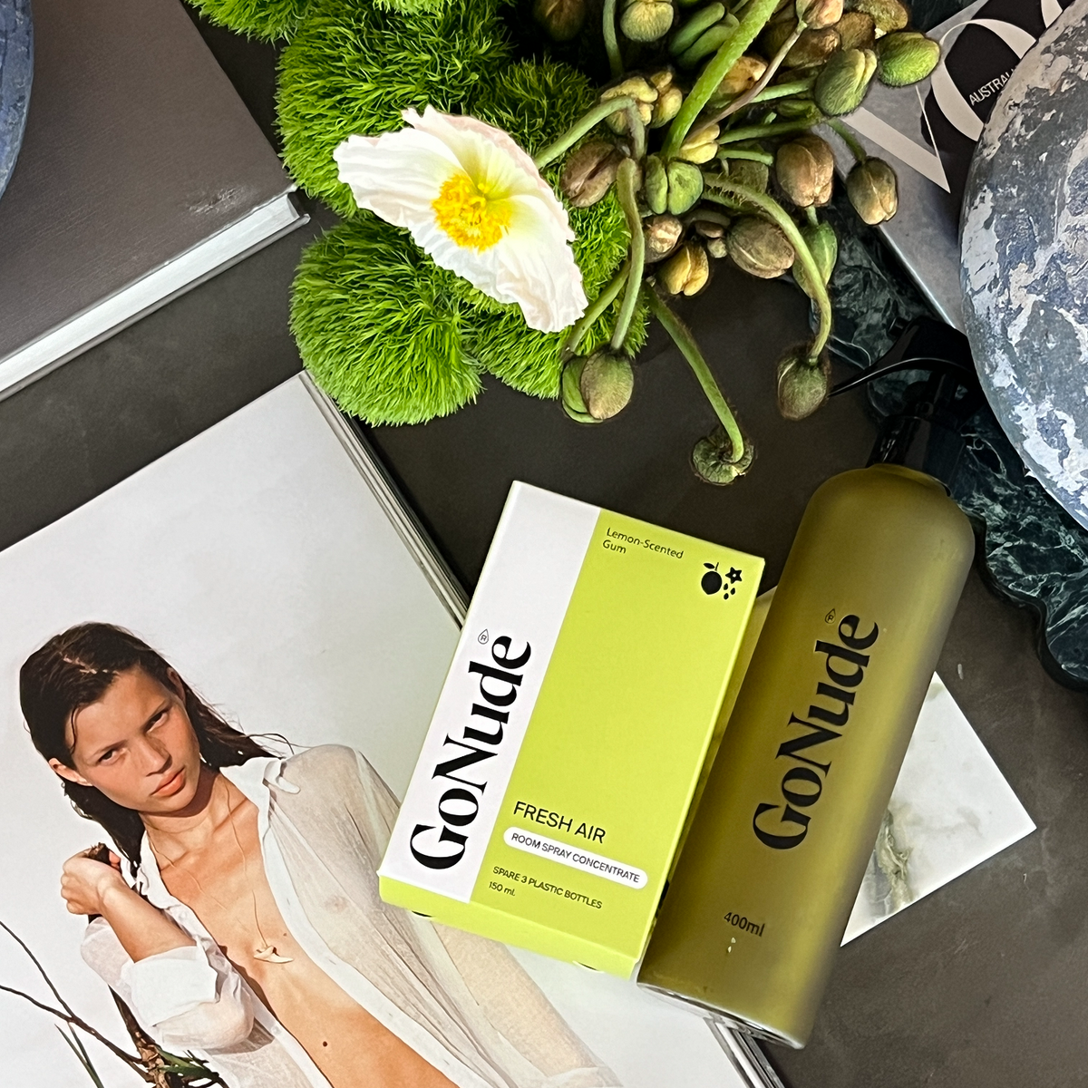 Go Nude Fresh Air Lemon-Scented Gum room spray carton beside an olive Go Nude refill bottle on a styled table