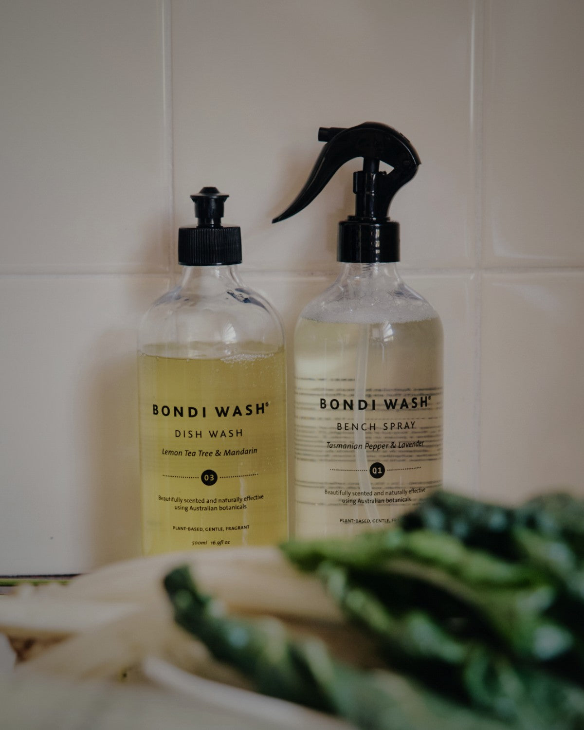 Bondi Wash Dish Wash and Bench Spray on a tiled kitchen bench with fresh greens