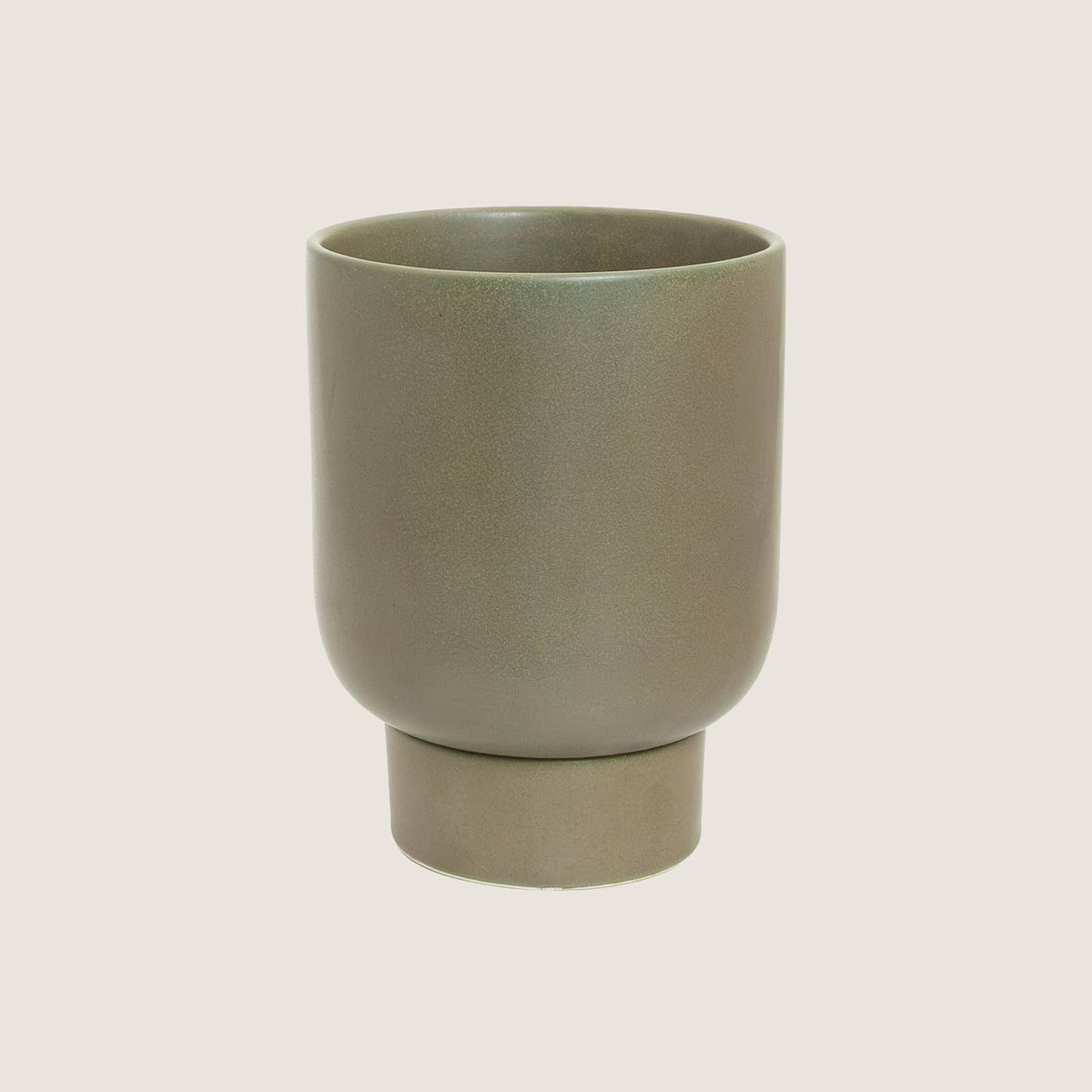Potted small Comet planter in Jade on a greige background