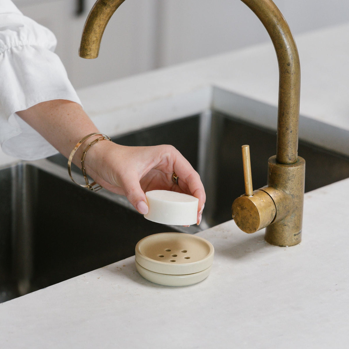 Seed and Sprout dish soap bar in use with a dish brush